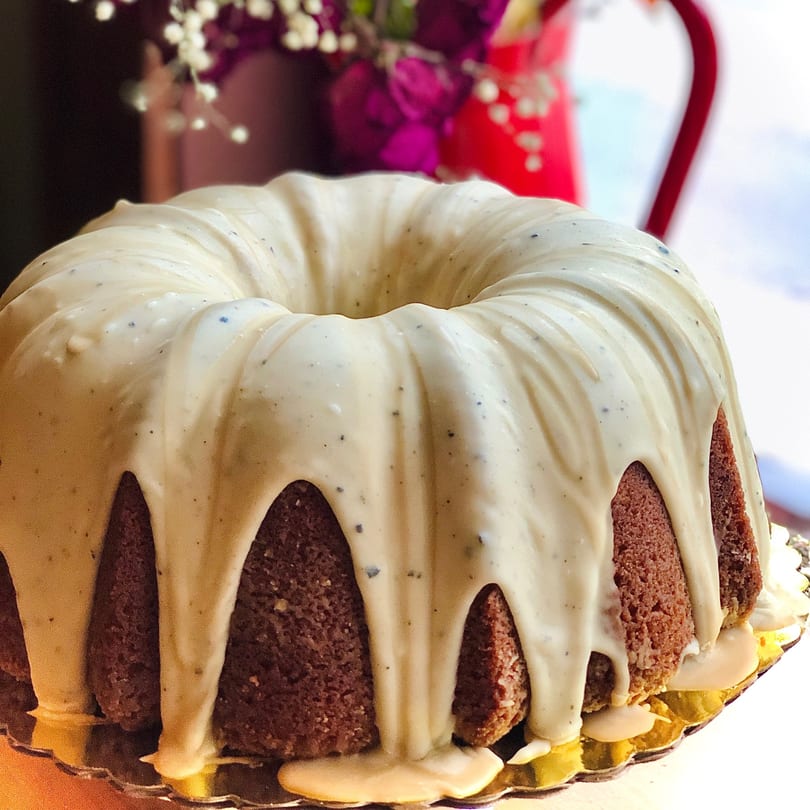 A bundt cake from The Bakeshop on 20th, with white icing drizzled over a brown cake.
